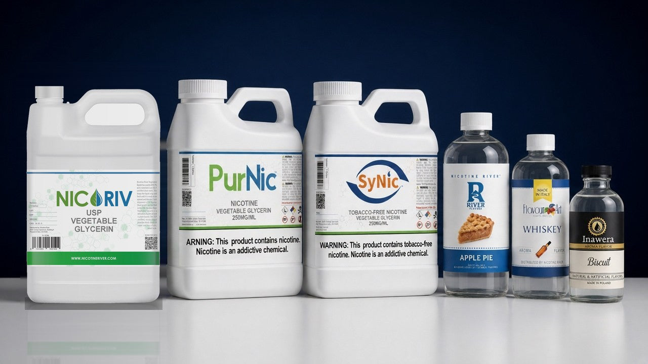 The Nicotine River range: NICORIV vegetable glycerin, PurNic and SyNic nicotine jugs and River, FlavourArt and Inawera flavor concentrates on a white table against a navy backdrop